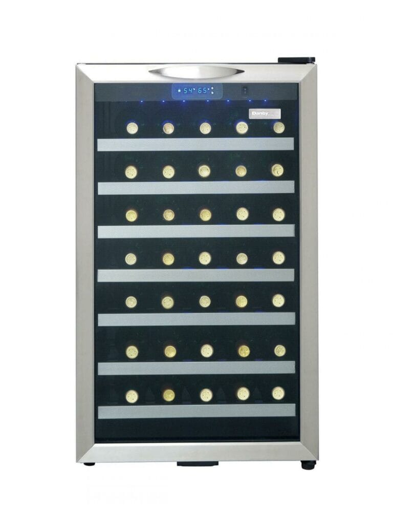 20 Inch Wine Fridge  Keeping your favourite wines at the correct temperature is an easy task with this elegant freestanding wine cooler by Danby. This unit is 4.0 cubic feet in size and can comfortably store and cool up to 45 bottles on its durable black wood shelves with stainless-steel trim. The stylish tinted-glass, and steel design makes it a classy addition to any room and the smart reversible hinge system allows you to adjust the door for either left or right-handed opening. The temperature is easily controlled and monitored by a precise digital thermostat with LED display while the cool blue LED track lighting beautifully showcases your wine collection. This model can be programmed anywhere between 5°C and 18°C (41 °F – 64°F) with the temperature remaining consistent due to the frost-free, fan-forced cooling system. This stunning wine cooler also comes with an 18-month warranty on parts and labour with handy in-home service